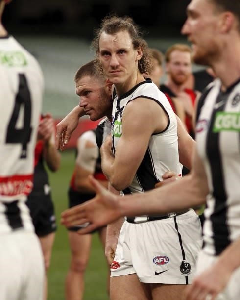 Chris Mayne of the Magpies is seen with Taylor Adams of the Magpies during the 2021 AFL Round 23 match between the Essendon Bombers and the...