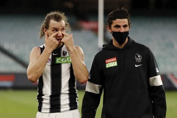 Chris Mayne of the Magpies is seen with Scott Pendlebury of the Magpies during the 2021 AFL Round 23 match between the Essendon Bombers and the...