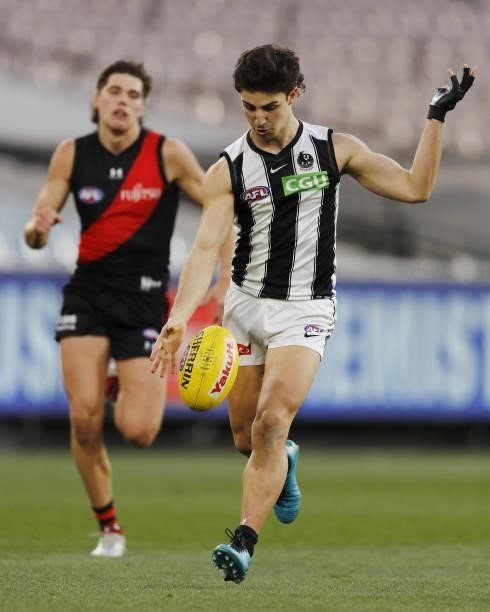 Josh Daicos of the Magpies kicks the ball during the 2021 AFL Round 23 match between the Essendon Bombers and the Collingwood Magpies at the...
