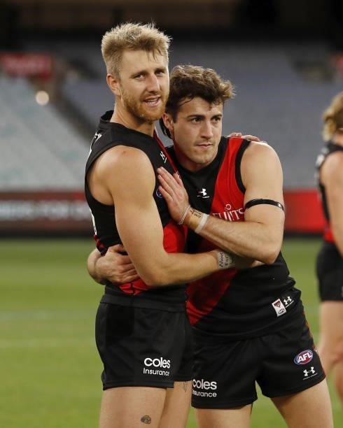 Dyson Heppell of the Bombers celebrates with Andrew McGrath of the Bombers during the 2021 AFL Round 23 match between the Essendon Bombers and the...