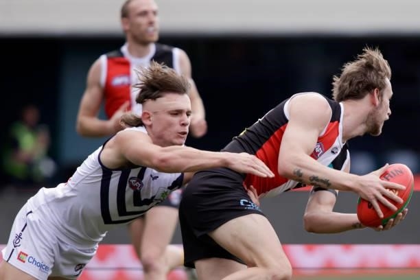 Jimmy Webster of the Saints is tackled by Caleb Serong of the Dockers during the 2021 AFL Round 23 match between the St Kilda Saints and the...