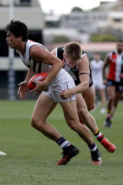 Bailey Banfield of the Dockers is tackled by Sebastian Ross of the Saints during the 2021 AFL Round 23 match between the St Kilda Saints and the...