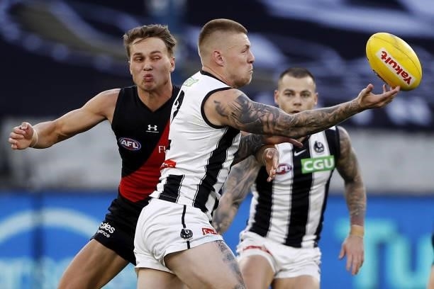 Jordan De Goey of the Magpies and Dylan Clarke of the Bombers compete for the ball during the 2021 AFL Round 23 match between the Essendon Bombers...
