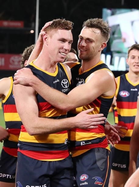Tom Lynch who is leaving the club is hugged by Brodie Smith during the 2021 AFL Round 23 match between the Adelaide Crows and the North Melbourne...