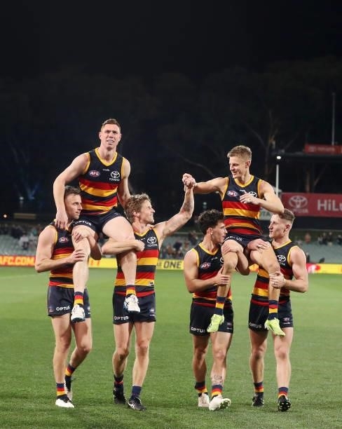 Crows players Tom Lynch and David Mackay who are leaving the club are chaired off the ground by Rory Sloane, Brodie Smith, Lachlan Murphy and Rory...