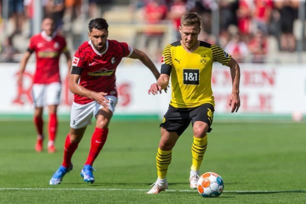 Vincenzo Grifo of SC Freiburg and Felix Passlack of Borussia Dortmund battle for the ball during the Bundesliga match between Sport-Club Freiburg and...