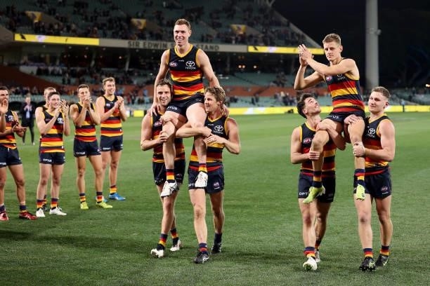 Tom Lynch and David Mackay of the Crows are chaired off after their last game for the club during the 2021 AFL Round 23 match between the Adelaide...