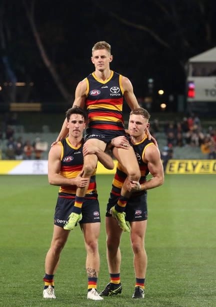 Retiring Crow David Mackay is chaired off by Lachlan Murphy and Rory Laird during the 2021 AFL Round 23 match between the Adelaide Crows and the...
