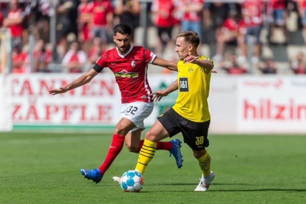 Vincenzo Grifo of SC Freiburg and Felix Passlack of Borussia Dortmund battle for the ball during the Bundesliga match between Sport-Club Freiburg and...