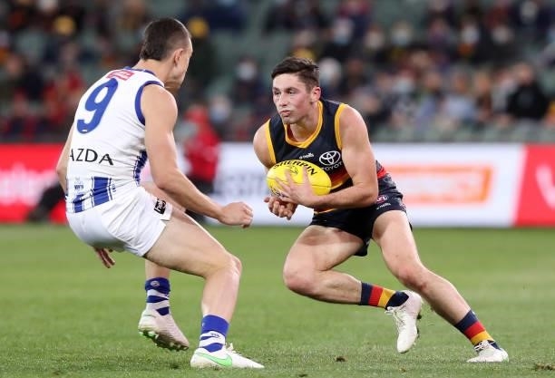 Chayce Jones of the Crows and Luke Davies-Uniacke of the Kangaroos during the 2021 AFL Round 23 match between the Adelaide Crows and the North...