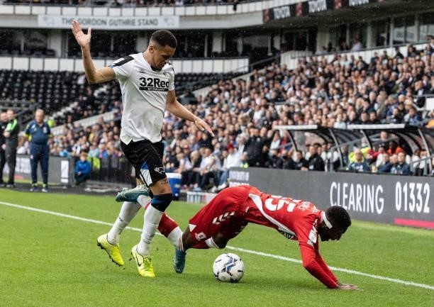 Middlesbrough's Isaiah Jones is brought down by Derby County's Ravel Morrison during the Sky Bet Championship match between Derby County and...