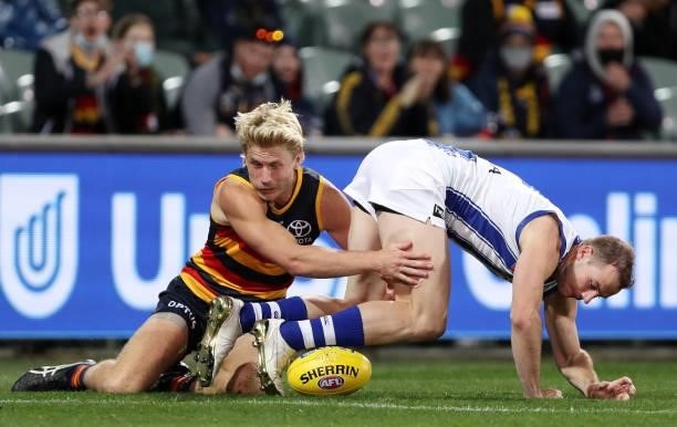 Josh Walker of the Kangaroos fumbles the ball in the goal square and Billy Frampton of the Crows pounces during the 2021 AFL Round 23 match between...