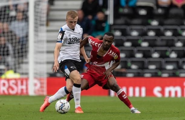 Middlesbrough's Marc Bola competing with Derby County's Louie Sibley during the Sky Bet Championship match between Derby County and Middlesbrough at...