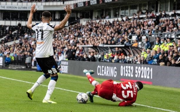 Middlesbrough's Isaiah Jones is brought down by Derby County's Ravel Morrison during the Sky Bet Championship match between Derby County and...
