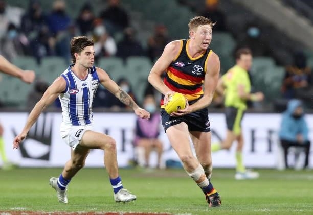 Kieran Strachan of the Crows and Jy Simpkin of the Kangaroos uring the 2021 AFL Round 23 match between the Adelaide Crows and the North Melbourne...