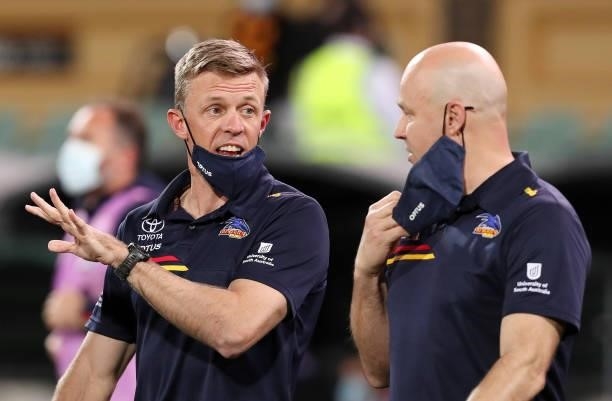 Nathan Van Berlo, Assistant Coach of the Crows and Matthew Nicks walk out for 3 quarter time address during the 2021 AFL Round 23 match between the...