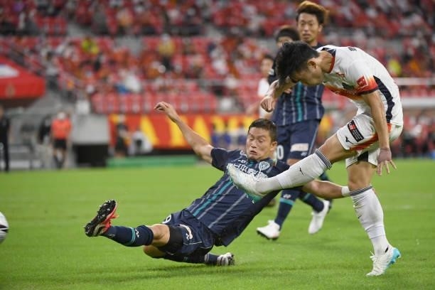 Ryoya Morishita of Nagoya Grampus shoots the ball under the challenge from Tatsuki Nara of Avispa Fukuoka during the J.League Meiji Yasuda J1 match...