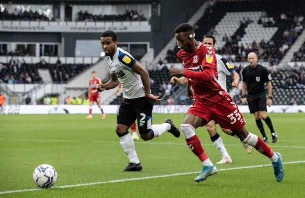 Middlesbrough's Isaiah Jones breaks under pressure from Derby County's Nathan Byrne during the Sky Bet Championship match between Derby County and...