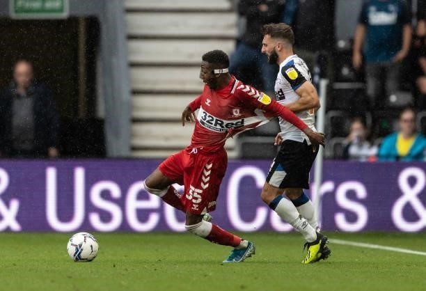 Middlesbrough's Isaiah Jones competing with Derby County's Graeme Shinnie during the Sky Bet Championship match between Derby County and...