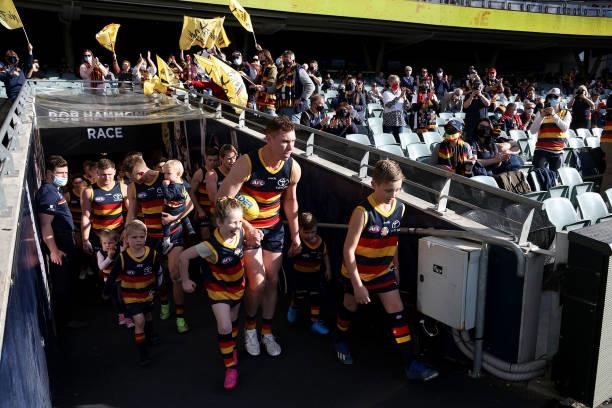 Tom Lynch and David Mackay of the Crows lead their team out for the last time during the 2021 AFL Round 23 match between the Adelaide Crows and the...