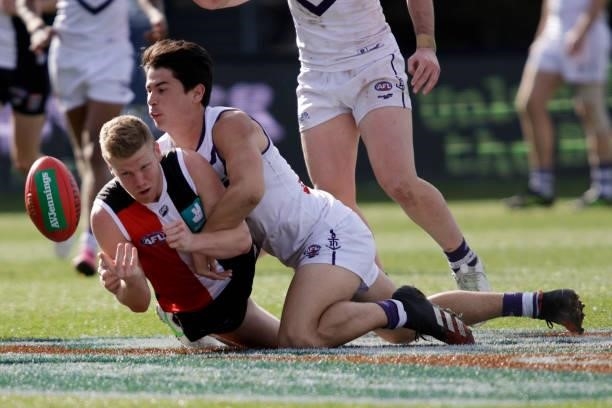 Dan Hannebery of the Saints is tackled by Bailey Banfield of the Dockers during the 2021 AFL Round 23 match between the St Kilda Saints and the...