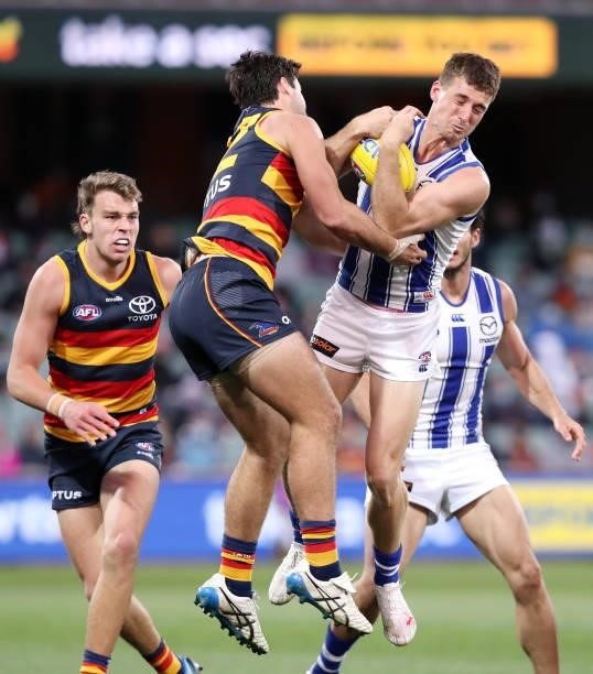 Shaun Atley of the Kangaroosn marks the ball from Darcy Fogarty of the Crows during the 2021 AFL Round 23 match between the Adelaide Crows and the...