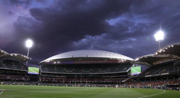 Storm clouds over Adelaide Oval during the 2021 AFL Round 23 match between the Adelaide Crows and the North Melbourne Kangaroos at Adelaide Oval on...
