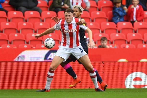 Harry Souttar of Stoke City shields the ball from Lyle Taylor of Nottingham Forest during the Sky Bet Championship match between Stoke City and...