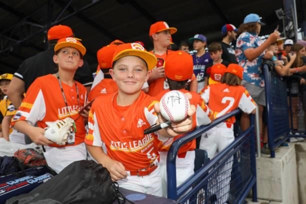 Young fan shows off an autographed ball before the game between the Los Angeles Angels and the Cleveland Indians at Historic Bowman Field on Sunday,...