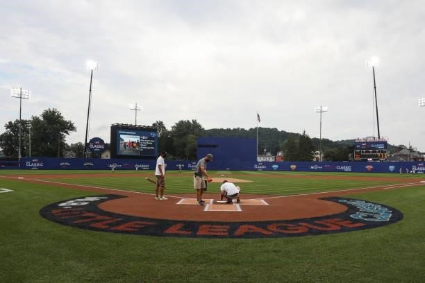 Members of the grounds crew prepare the field before the game between the Los Angeles Angels and the Cleveland Indians at Historic Bowman Field on...