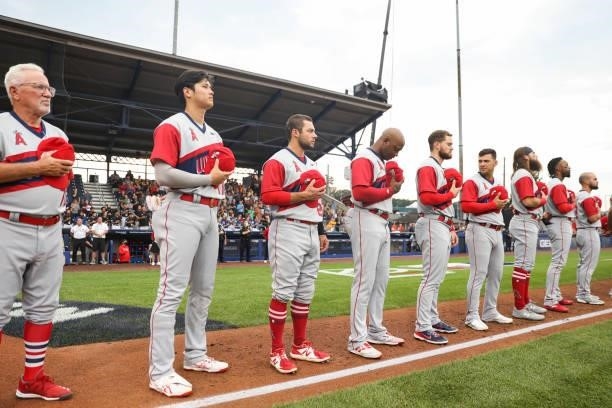 The Los Angeles Angels are seen during the national anthem during the game between the Los Angeles Angels and the Cleveland Indians at Historic...