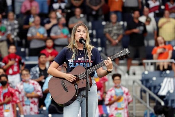 Year old singer/songwriter Emelise Muñoz sings the national anthem prior to the game between the Los Angeles Angels and the Cleveland Indians at...