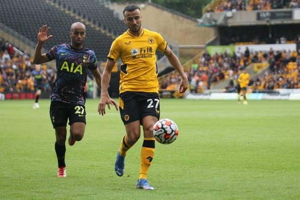 Lucas of Tottenham Hotspur battles for the ball with Romain Saïss of Wolverhampton Wanderers during the Premier League match between Wolverhampton...