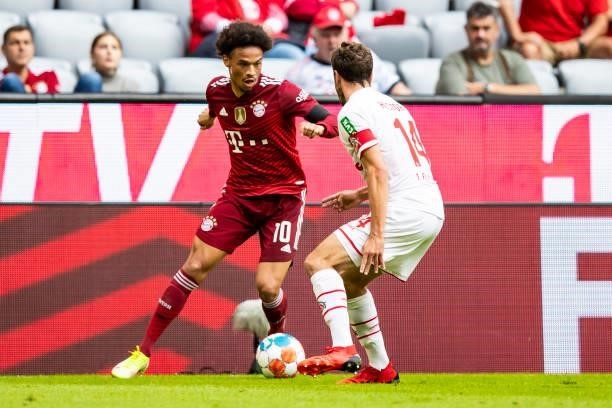 Leroy Sane of Bayern Muenchen and Jonas Hector of 1. FC Koeln battle for the ball during the Bundesliga match between FC Bayern Muenchen and 1. FC...