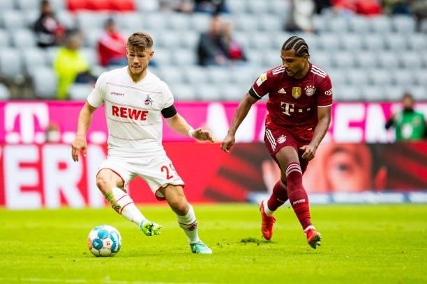 Jan Thielmann of 1. FC Koeln and Serge Gnabry of Bayern Muenchen battle for the ball during the Bundesliga match between FC Bayern Muenchen and 1. FC...