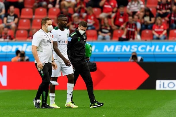 Marcus Thuram of Borussia Moenchengladbach injured during the Bundesliga match between Bayer 04 Leverkusen and Borussia Moenchengladbach at BayArena...