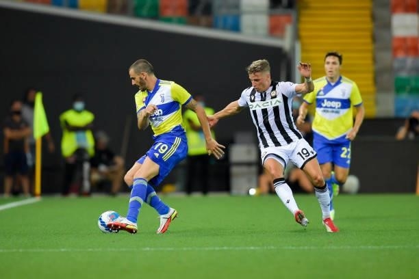 Juventus player Leonardo Bonucci and Udinese player Jens Larsen during the Serie A match between Udinese Calcio v Juventus at Dacia Arena on August...