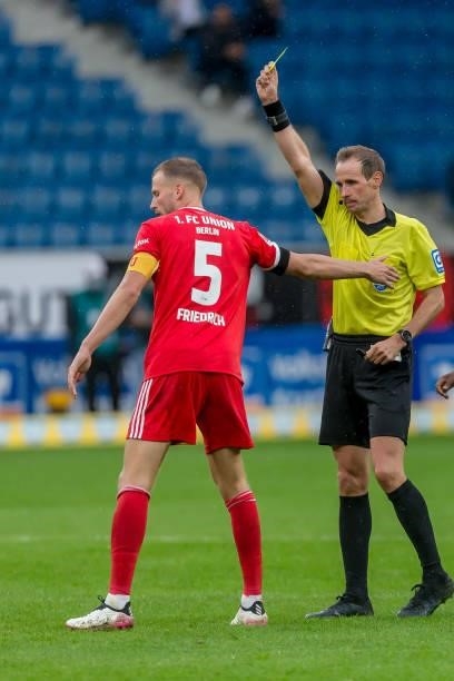 Referee Sascha Stegemann shows Marvin Friedrich of 1.FC Union Berlin und the yellow card during the Bundesliga match between TSG Hoffenheim and 1. FC...