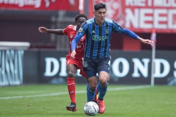 Edson Alvarez of AFC Ajax and Queensy Menig of Rangers FC Battle for the ball during the Dutch Eredivisie match between FC Twente and Ajax at De...