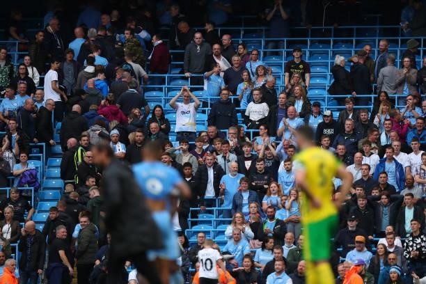 Fans of Manchester City applaud from safe standing rail seats during the Premier League match between Manchester City and Norwich City at Etihad...