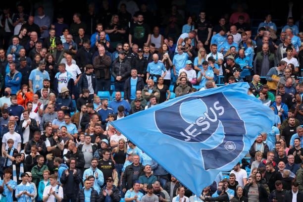 Fans of Manchester City wave a flag for Gabriel Jesus of Manchester City during the Premier League match between Manchester City and Norwich City at...