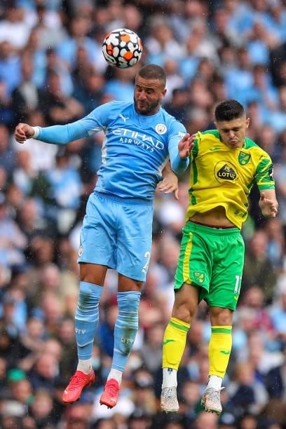 Kyle Walker of Manchester City and Przemyslaw Plachets of Norwich City challenge for a header during the Premier League match between Manchester City...