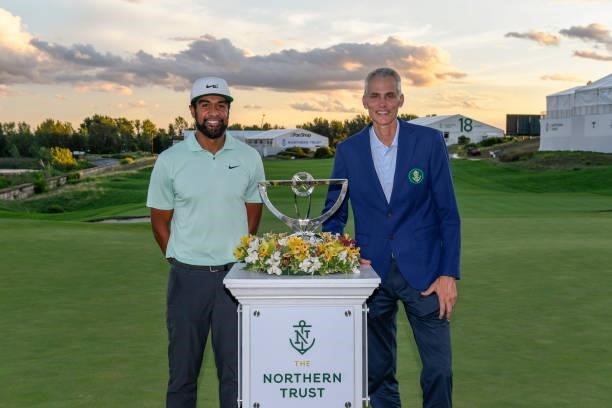 Tony Finau poses with Michael O’Grady the CEO of Northern Trust during the trophy ceremony in the weather delayed final round of THE NORTHERN TRUST...