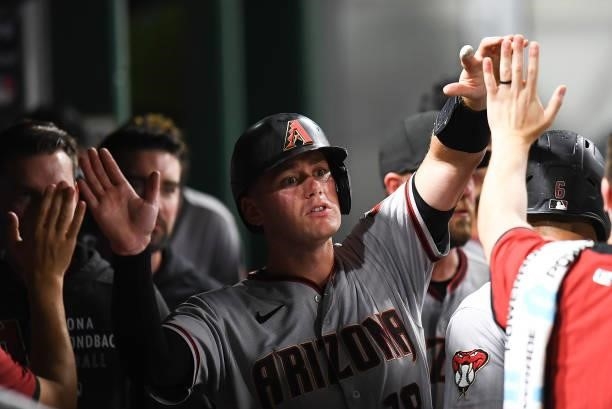 Carson Kelly of the Arizona Diamondbacks celebrates with teammates after scoring during the fifth inning against the Pittsburgh Pirates at PNC Park...