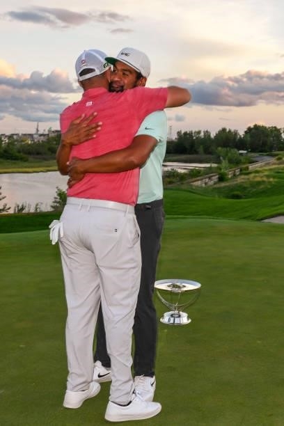 Tony Finau gets a hug from Jon Rahm of Spain after he won in a playoff during the weather delayed final round of THE NORTHERN TRUST at Liberty...