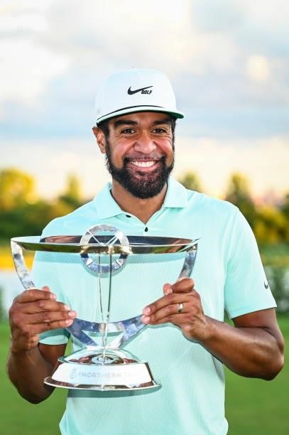 Tony Finau smiles with the tournament trophy following his playoff victory during the final round of THE NORTHERN TRUST, the first event of the...