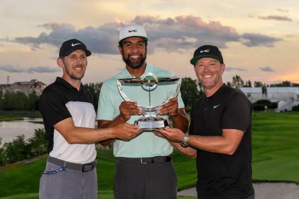 Tony Finau poses with his caddie, Mark Urbanek, left, and coach Boyd Summerhays, right, after winning in a playoff during the weather delayed final...