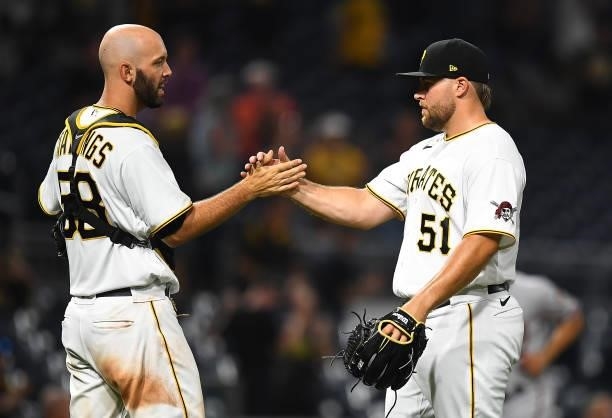 David Bednar celebrates with Jacob Stallings of the Pittsburgh Pirates after a 6-5 win over the Arizona Diamondbacks at PNC Park on August 23, 2021...