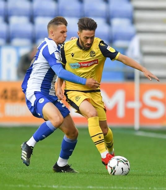 Bolton Wanderers' Josh Sheehan battles with Wigan Athletic's Scott Smith during the Carabao Cup Second Round match between Wigan Athletic and Bolton...