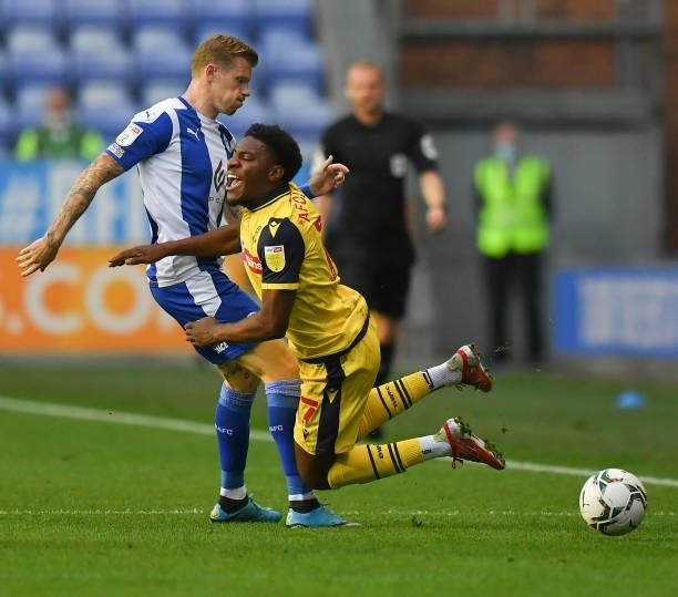 Bolton Wanderers' Oladapo Afolayan is fouled by Wigan Athletic's James McClean during the Carabao Cup Second Round match between Wigan Athletic and...